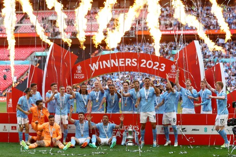 Para pemain Manchester City merayakan dengan trofi setelah memenangkan Piala FA di Stadion Wembley, London, Inggris, Sabtu (3/6/2023). Foto: Action Images via Reuters/Paul Childs