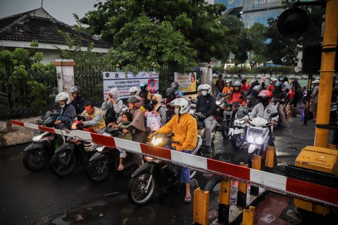 Sejumlah pengendara menunggu kereta api melintas di pintu perlintasan kereta api Pasar Minggu, Jakarta, Rabu (21/6/2023).  Foto: Jamal Ramadhan/kumparan