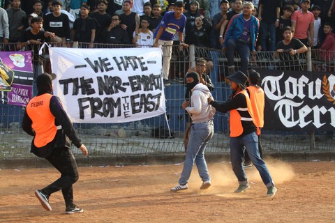 Petugas mengamankan seorang yang diduga suporter Arema FC saat pertandingan Liga 1 Persik Kediri melawan Arema FC di Stadion Brawijaya, Kota Kediri, Jawa Timur, Sabtu (15/7/2023). Foto: Prasetia Fauzani/Antara Foto