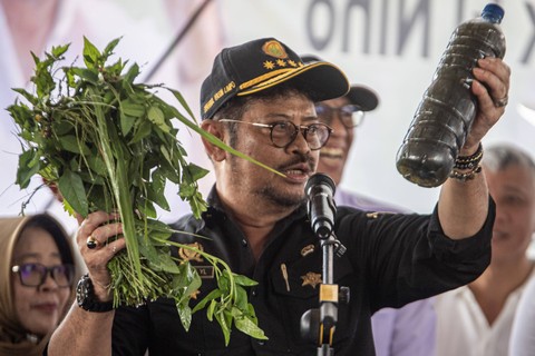 Menteri Pertanian Syahrul Yasin Limpo menunjukkan cara pembuatan cairan Biosaka saat penanaman padi perdana Gerakan Nasional El Nino di Desa Pelabuhan Dalam, Kecamatan Pemulutan, Kabupaten Ogan Ilir (OI), Sumatera Selatan, Senin (7/8/2023). Foto: ANTARA FOTO/Nova Wahyudi