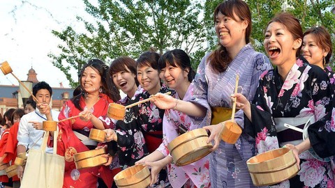 Sejumlah perempuan Jepang memakai yukata berpartisipasi dalam acara 'uchimizu', yaitu menyiramkan air pada musim panas guna mendinginkan lingkungan sekitar.