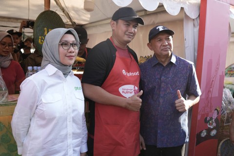 Sulistyono, pemilik kuliner Juara Lokal Solo Leker Gajahan Bapak Fathoni Jr. (tengah) berfoto bersama Menkop UKM Teten Masduki, pada perayaan Hari UMKM Nasional Expo 2023 di Solo, Sabtu (12/8/2023). Foto: Dok. GoTo