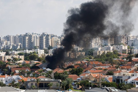 Pemandangan udara menunjukkan kendaraan terbakar saat roket diluncurkan dari Jalur Gaza, di Ashkelon, Israel selatan, Sabtu (7/10/2023). Foto: Ilan Rosenberg/REUTERS
