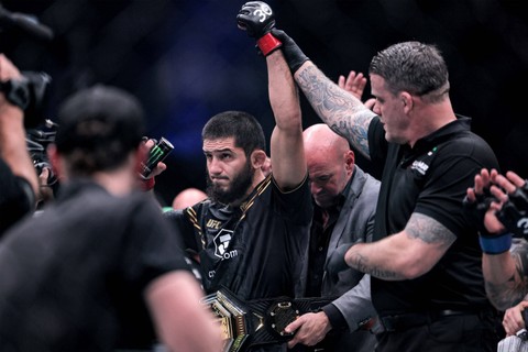 Islam Makhachev (tengah) dari Rusia dinyatakan sebagai pemenang dalam pertarungan Kelas Ringan melawan Alexander Volkanovski dari Australia pada ajang Ultimate Fighting Championship 294 (UFC) di Etihad Arena di Abu Dhabi pada Minggu (22/10/2023). Foto: Giuseppe Cacace/AFP
