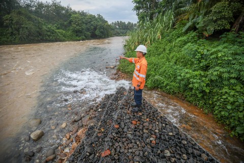 Petugas memeriksa aliran air sisa proses penambangan emas Martabe yang dialirkan ke Sungai Batangtoru, Tapanuli Selatan, Sumatera Utara, Sabtu (18/11). Foto: Aditia Noviansyah/kumparan