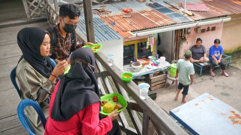 Pengunjung destinasi cagar budaya yang juga diperbolehkan untuk mengikuti tradisi budaya sedekah kampung tahunan di Palembang, Sabtu (23/12) Foto: abp/urban id