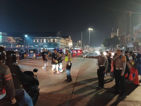 Polisi mengatur lalu lintai usai warga membubarkan diri setelah merayakan tahun baru di Kota Tua. Foto: Twitter/@TMCPoldaMetro