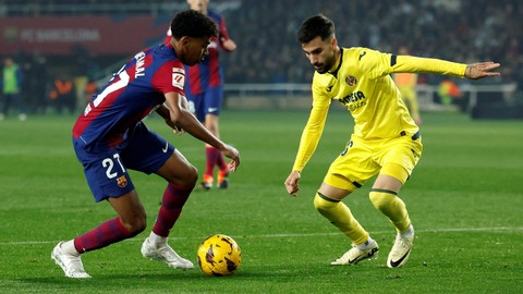 Lamine Yamal duel dengan Alex Baena saat laga Barcelona vs Villarreal dalam pekan ke-22 Liga Spanyol 2023/24 di Estadi Olimpic Lluis Companys pada Minggu (28/1/2024) dini hari WIB. Foto: REUTERS/Albert Gea