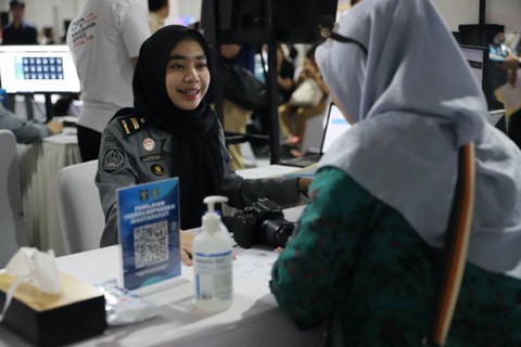 Petugas Imigrasi memproses pembuatan paspor pada acara CFD Immigration Service di Parkir Timur Senayan, Jakarta, Minggu (28/1/2024). Foto: Iqbal Firdaus/kumparan