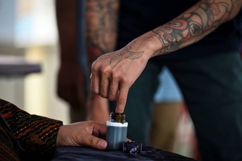 Seorang warga binaan menyelupkan tangan kedalam tinta sebagai tanda sudah menyalurkan hak suara di TPS khusus Lapas Salemba, Jakarta, Rabu (14/2/2024). Foto: Erlangga Bregas Prakoso/ANTARA FOTO