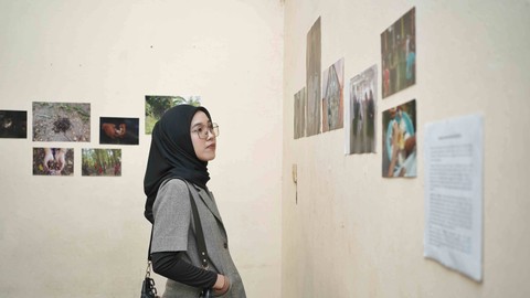 Seorang pengunjung yang melihat pajangan foto dalam pameran fotografi bertema GARANG yang digagas komunitas Ghompok Kolektif di Rumah Sintas Palembang, Senin (26/2) Foto: ary priyanto/urban id