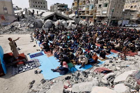 Warga Palestina menghadiri salat Jumat di dekat reruntuhan masjid yang hancur akibat serangan Israel, di tengah konflik yang sedang berlangsung antara Israel dan Hamas, di Rafah di selatan Jalur Gaza, Jumat (1/3/2024). Foto: Mohammed Salem/REUTERS