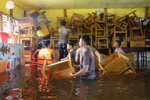 Polisi mengevakuasi peralatan sekolah di SDN 26 Desa Sidomulyo yang terendam banjir. Foto: Dok. Polres Melawi