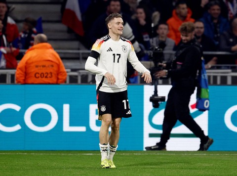 Pemain Timnas Jerman Florian Wirtz usai mencetak gol ke gawang Timnas Prancis pada pertandingan persahabatan di Stadion Groupama, Lyon, Prancis, Sabtu (23/3/2024). Foto: Benoit Tessier/REUTERS