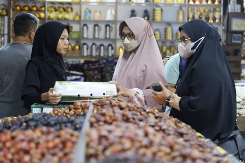 Pedagang melayani pembeli buah kurma di salah satu toko kurma kawasan Pasar Tanah Abang, Jakarta, Minggu, (24/3/2024). Foto: Iqbal Firdaus/kumparan
