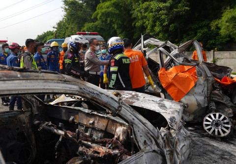 Polisi memeriksa bangkai kendaraan yang mengalami kecelakaan di Tol Jakarta-CIkampek KM 58, Karawang Timur, Jawa Barat, Senin (8/4/2024). Foto: Akbar Nugroho Gumay/ANTARA FOTO