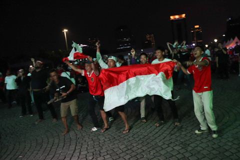 Warga menyaksikan pertandingan Timnas Indonesia U-23 melawan Irak pada pertandingan perebutan tempat ketiga Piala Asia U-23 2024 di Plaza Selatan Monumen Nasional (Monas), Jakarta, Kamis (2/5/2024). Foto: Jamal Ramadhan/kumparan