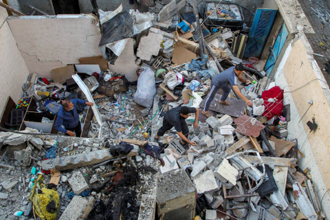 Warga Palestina memeriksa sebuah rumah yang rusak akibat serangan Israel, di tengah konflik antara Israel dan Hamas, di Rafah, di selatan Jalur Gaza, Kamis (9/5/2024). Foto: Hatem Khaled/REUTERS