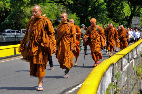 Sejumlah Bhikkhu Thudong berjalan kaki menyusuri jalan raya di Bengkal, Kranggan, Temanggung, Jawa Tengah, Minggu (19/5/2024). Foto: Anis Efizudin/ANTARA FOTO