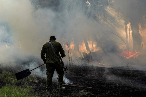Militer Israel memadamkan api di tengah konflik lintas batas antara Hizbullah dan pasukan Israel di dekat perbatasan Israel dengan Lebanon, di Israel utara, Selasa (4/6/2024). Foto: Ayal Margolin/REUTERS