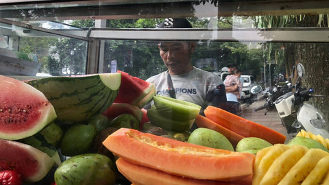 Surya (47), penjual rujak yang dagangannya laris akibat digelarnya aksi solidaritas untuk Palestina, di jalan Diponegoro, Bandung, Sabtu (8/6/2024). Foto: Robby Bouceu/kumparan