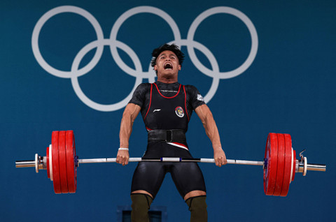 Rizki Juniansyah beraksi di cabor angkat besi Olimpiade Paris 2024. Foto: REUTERS/Amanda Perobelli