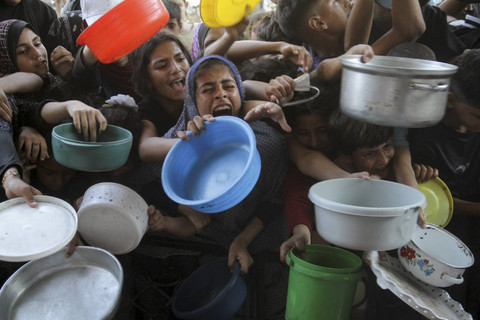 Warga Palestina bereaksi saat menunggu untuk menerima makanan yang dimasak oleh dapur umum, di tengah krisis kelaparan akibat konflik antara Israel dan Hamas yang terus berlanjut di Jalur Gaza utara, Kamis (15/8/2024). Foto: Mahmoud Issa/REUTERS