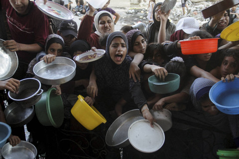 Warga Palestina bereaksi saat mereka menunggu untuk menerima makanan yang dimasak oleh dapur umum, di tengah krisis kelaparan akibat konflik antara Israel dan Hamas yang terus berlanjut di Jalur Gaza utara, Kamis (15/8/2024). Foto: Mahmoud Issa/REUTERS