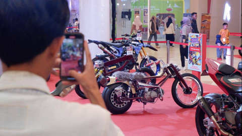 Pengunjung memotret motor modifikasi di Honda Modif Contest 2024 di Makassar, Sabtu (17/8). Foto: Aditya Pratama Niagara/kumparan