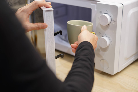 Ilustrasi memasukkan air dalam gelas ke microwave untuk memanaskan nasi. Foto: pixs4u/Shutterstock