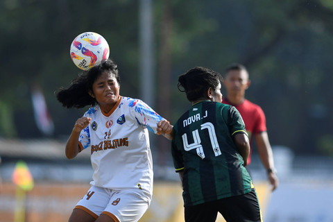 Pemain bola putri Bangka Belitung Astrid Ananda berebut bola dengan pemain bola putri Papua Pegunungan Nova saat perebutan juara ketiga sepak bola putri PON XXI Aceh-Sumut di Stadion Mini Pancing, Deli Serdang, Sumatera Utara, Sabtu (14/9/2024). Foto: Iggoy el Fitra/Antara Foto