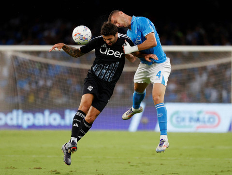 Pemain Napoli Alessandro Buongiorno berduel dengan pemain Como FC Patrick Cutrone pada pekan ketujuh Serie A Liga Italia di Stadion Diego Armando Maradona, Naples, Italia, Jumat (5/10/2024). Foto: Ciro de Luca/Reuters