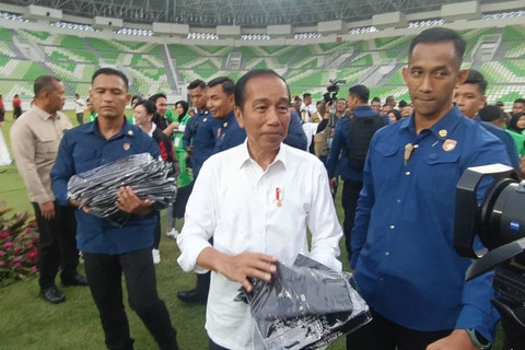 Presiden Joko Widodo membagikan kaus saat meresmikan Stadion Utama Sumatera Utara di Deli Serdang, Sumatera Utara, Selasa (15/10/2024). Foto: Zamachsyari/kumparan