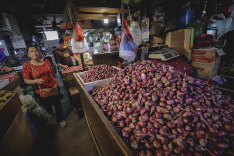 Calon pembeli melintas di dekat bawang merah yang dijual di Pasar Senen, Jakarta, Jumat (1/11/2024). Foto: Jamal Ramadhan/kumparan