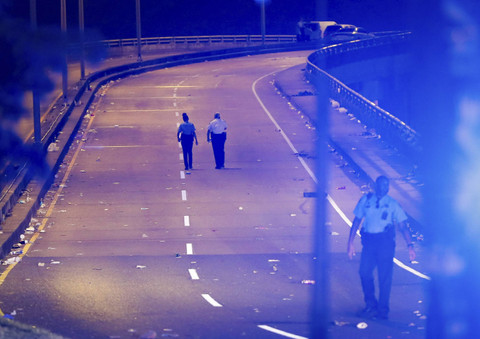 Polisi New Orleans berjalan di jembatan Almonaster Avenue setelah penembakan mematikan di New Orleans, Minggu (17/11/2024). Foto: David Grunfeld/The New Orleans Advocate via AP