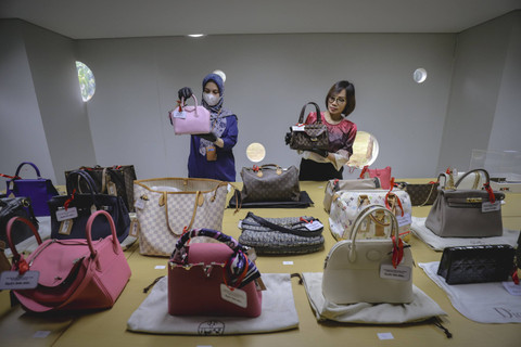 Pegawai Komisi Pemberantasan Korupsi (KPK) menunjukan tas mewah hasil sitaan KPK di Rumah Penyimpanan Benda Sitaan dan Barang Rampasan (Rupbasan) KPK yang berlokasi di Jalan Dewi Sartika, Cawang, Kramat Jati, Jakarta Timur, Kamis (5/12/2024). Foto: Jamal Ramadhan/kumparan