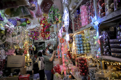 Pengunjung memilih aksesoris natal di Jalan Pintu Kecil, Tambora, Jakarta Barat, Selasa (17/12/2024). Foto: Jamal Ramadhan/kumparan