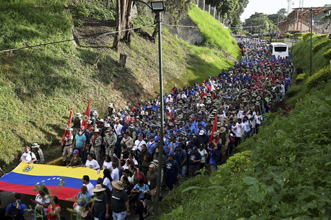Sejumlah anggota Milisi Bolivarian dan pendukung Presiden Venezuela Nicolas Maduro berjalan saat untuk melakukan pembacaan sumpah di Caracas, Venezuela, Rabu (7/1/2025). Foto: Gaby Oraa/REUTERS
