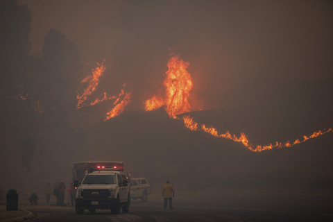 Seorang petugas pemadam kebakaran menyaksikan kobaran api dari Kebakaran Hughes merambat ke atas bukit di Lake Hughes Road di Castaic, lingkungan barat laut Los Angeles County, California, AS, Rabu (22/1/2025). Foto: Apu Gomes/AFP