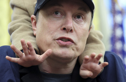 Pengusaha Elon Musk menggedong anaknya saat melakukan pertemuan di Gedung Putih, Washington DC, Amerika Serikat, Selasa (11/2/2025). Foto: Kevin Lamarque/REUTERS