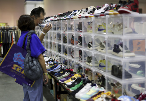 Dua pengunjung melihat koleksi sepatu saat Sneaker Con Southeast Asia di Marina Bay Sands, Singapura, Sabtu (22/2/2025). Foto: Edgar Su/REUTERS