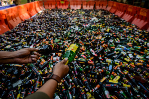 Petugas Satpol PP menata botol minuman keras saat pemusnahan di halaman Kantor Wali Kota Tangerang, Banten, Jumat (28/2/2025).  Foto: ANTARA FOTO/Putra M. Akbar
