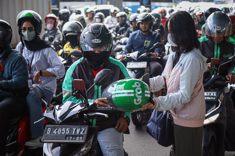 Pengemudi ojek online (ojol) menunggu datangnya penumpang di Halte LRT Pancoran, Jakarta, Rabu (12/3/2025). Foto: Iqbal Firdaus/kumparan