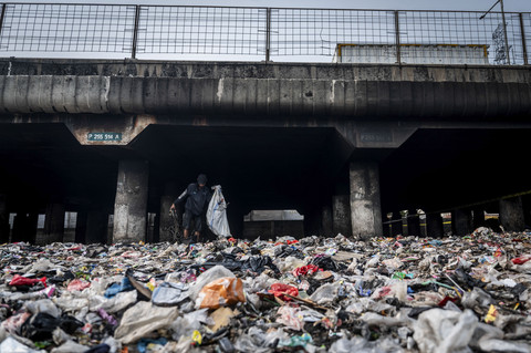 Warga memungut sampah di kolong jalan tol dalam kota, Kelurahan Papanggo, Jakarta, Rabu (16/3/2025). Foto: Bayu Pratama S/ANTARA FOTO