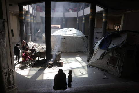 Warga Palestina yang mengungsi duduk di dalam gedung kampus Universitas Islam yang rusak di Kota Gaza, Rabu (16/4/2025). Foto: Bashar Taleb/AFP