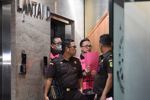 Direktur Pemberitaan JakTV Tian Bahtiar (kiri) bersama advokat Junaedi Saibih (kanan) dikawal petugas menuju mobil tahanan usai menjalani pemeriksaan di Gedung Kejaksaan Agung, Jakarta, Selasa (22/4/2025). Foto: Indrianto Eko Suwarso/ANTARA FOTO