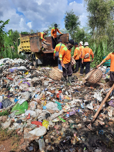 Petugas tengah membersihkan sampah yang dibuang di kawasan hutan negara di Playen, Gunungkidul. Foto: Dok. DLH Gunungkidul