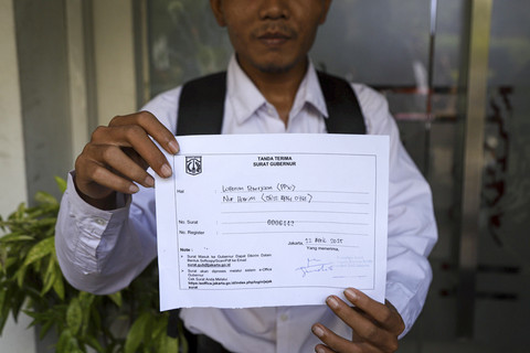 Warga menunjukan tanda terima Surat Gubernur di Balai Kota DKI Jakarta, Selasa (22/4/2025). Foto: Iqbal Firdaus/kumparan