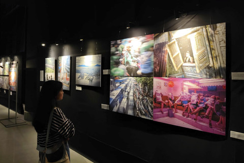 Pengunjung mengamati karya foto pada pameran foto 'Sing Penting Madhang' di Gallery Gelanggang Inovasi dan Kreativitas (GIK) Universitas Gadjah Mada (UGM), Kamis (1/5/2025) malam. Foto: Arfiansyah Panji Purnandaru/kumparan