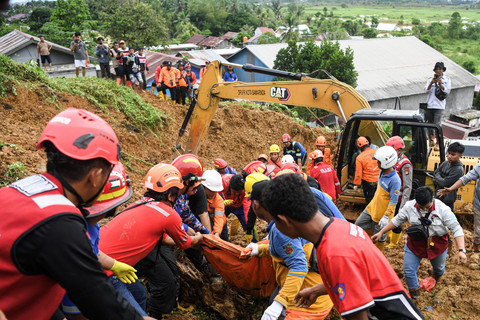 Petugas gabungan mengangkat kantong yang berisi jenazah dari korban tanah longsor yang terjadi di kawasan Belimau, Samarinda, Kalimantan Timur, Senin (12/5/2025). Foto: M Risyal Hidayat/ANTARA FOTO